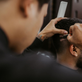 barber makes hair tattoo